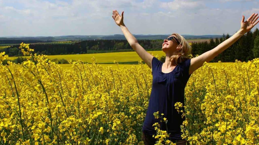 woman with a positive attitude because she knows it will help her succeed