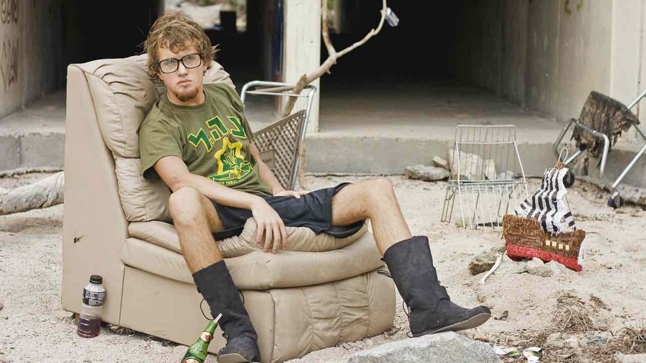 poor musician sitting on his outdoor couch