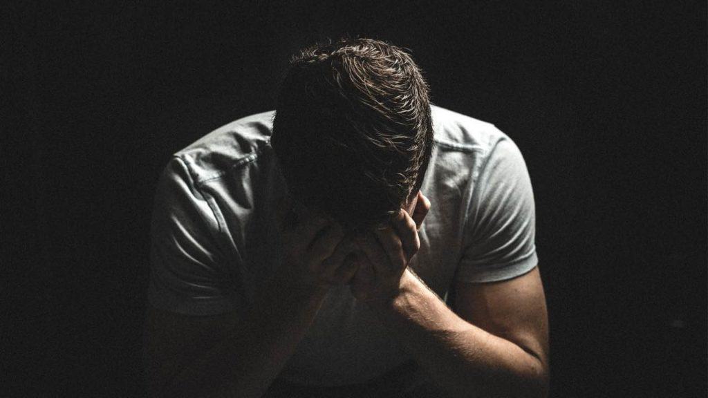 man with his head down