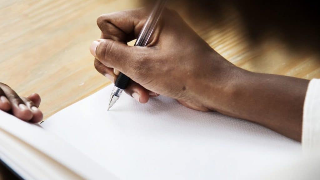 a hand with a pen
